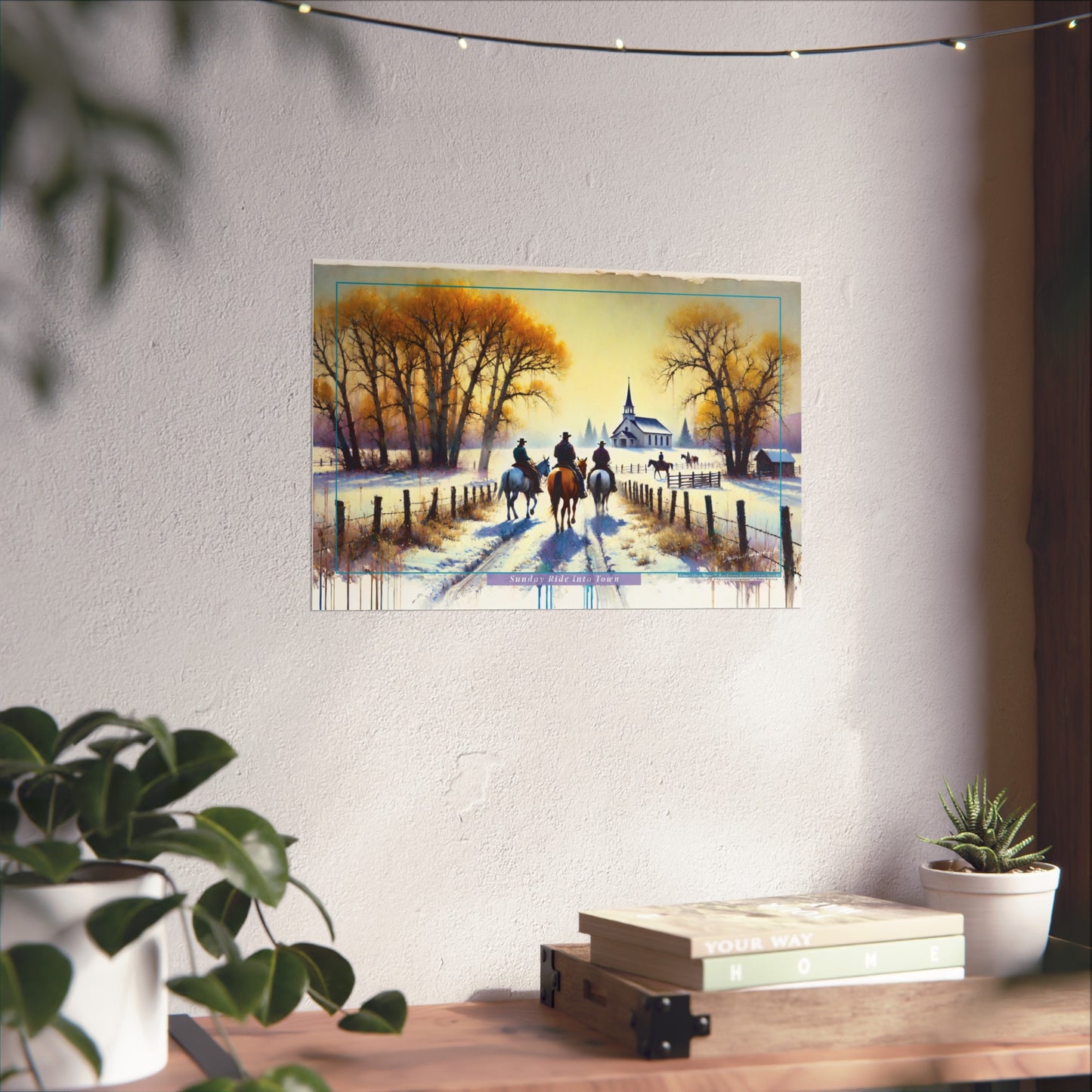 Painting of a snowy landscape with cowboys on horseback hanging on a wall above a desk.