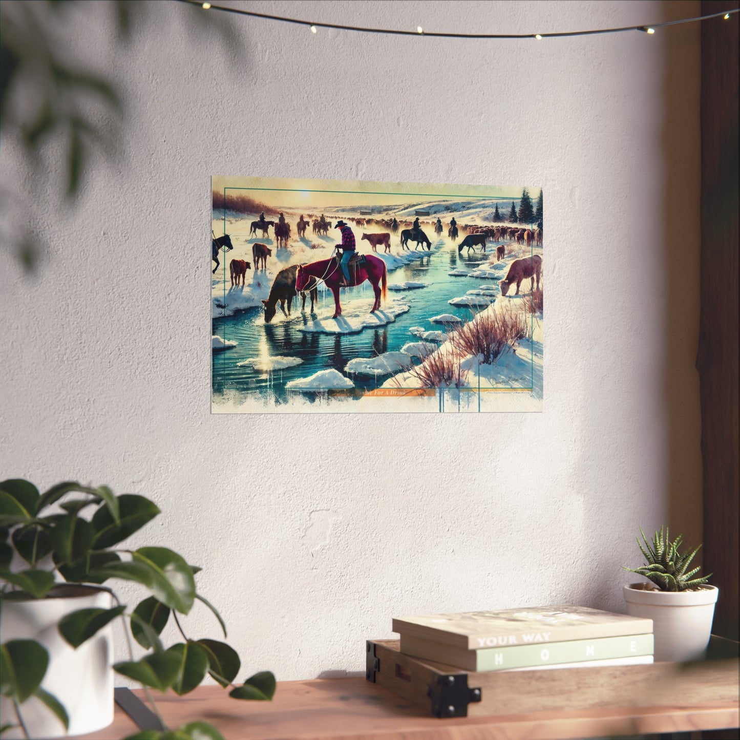 Poster of a winter landscape with cowboys and horses hanging on a wall.