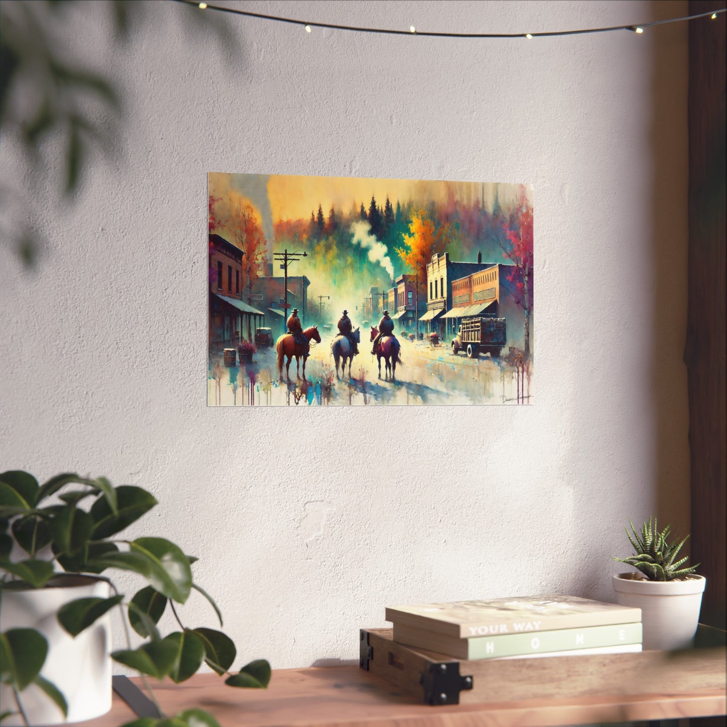 Colorful painting of a town scene with cowboys on horses hanging on a wall.