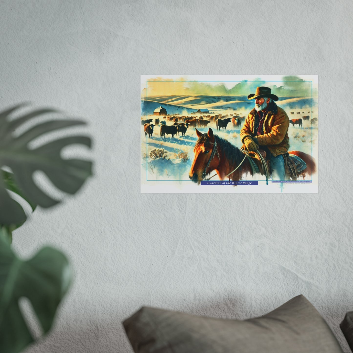 Framed artwork of a cowboy on a horse with a pastoral scene in the background, displayed on a wall.