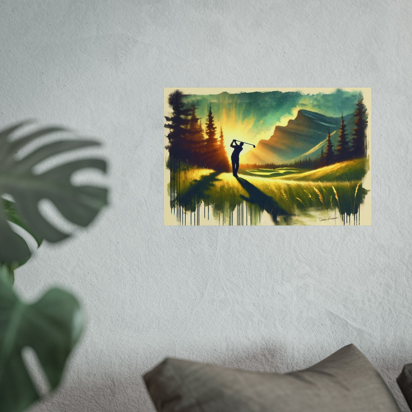 Art print of a golf player on a golf course with mountains and trees, hanging on a wall.
