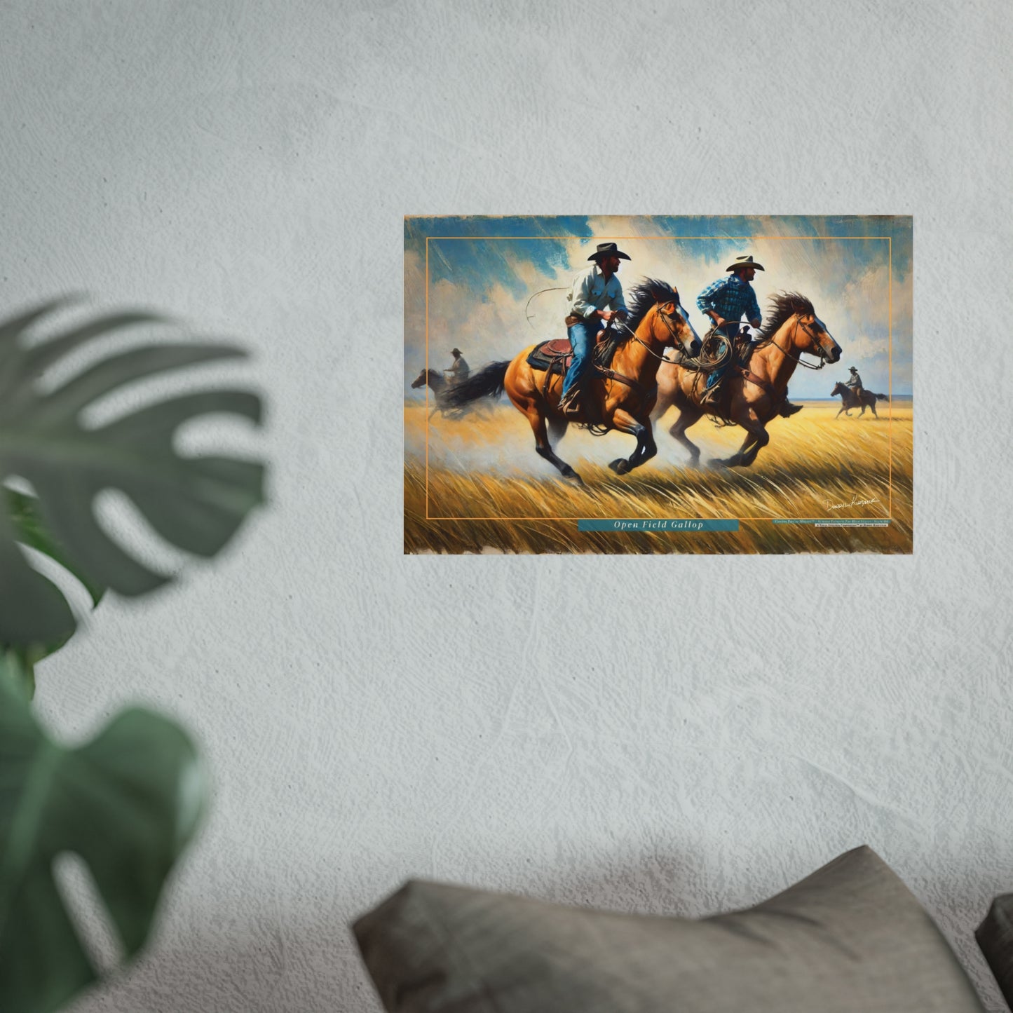 Framed artwork of two cowboys on horseback in a desert setting, hanging on a wall.
