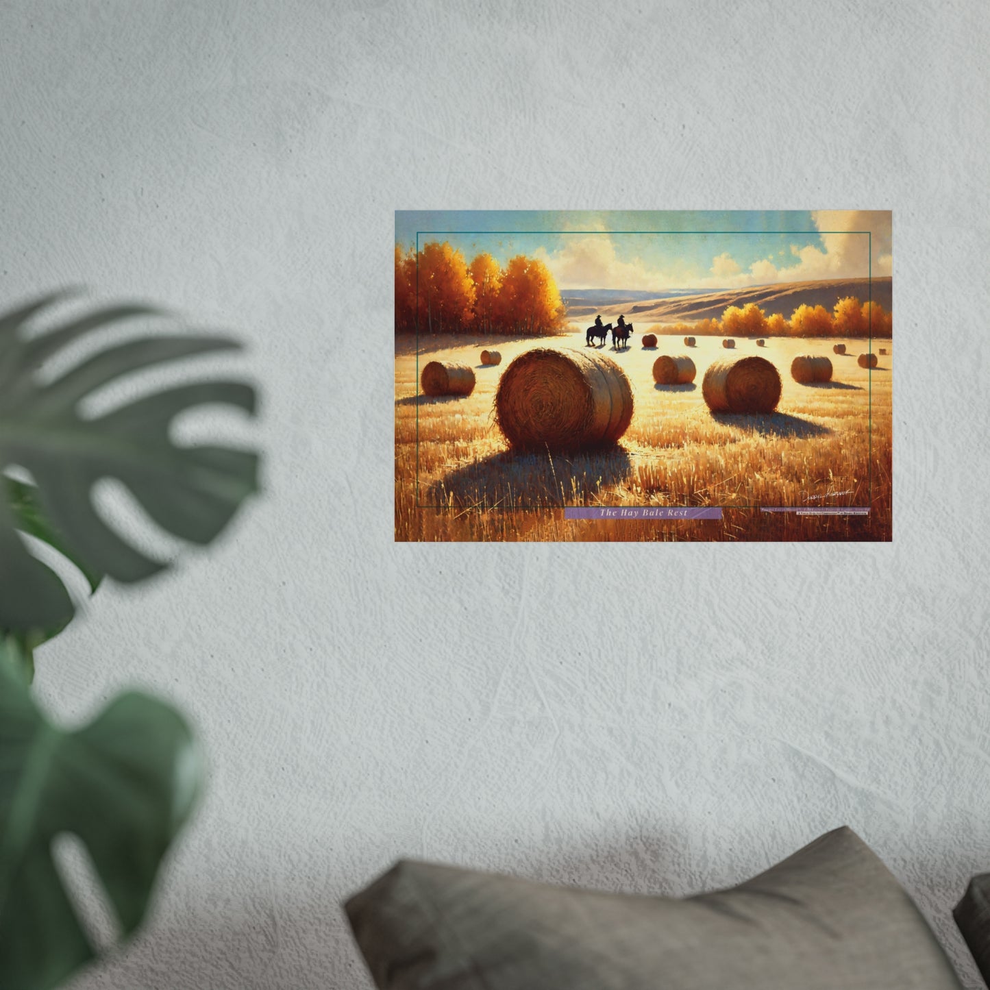Poster of a scenic landscape with hay bales, cowboys and trees on a wall.