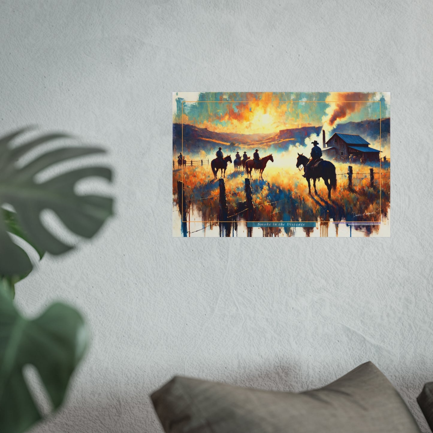 Poster of a sunset scene with cowboys on horses hanging on a wall.