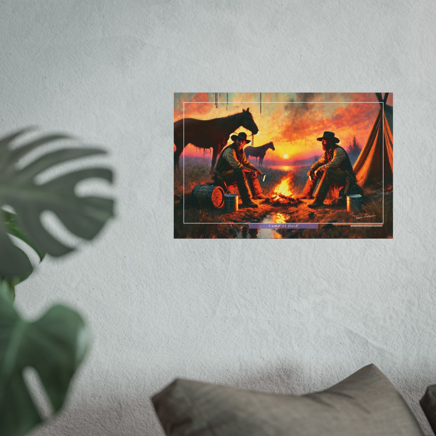 Framed artwork of two cowboys by a campfire with horses on a wall.
