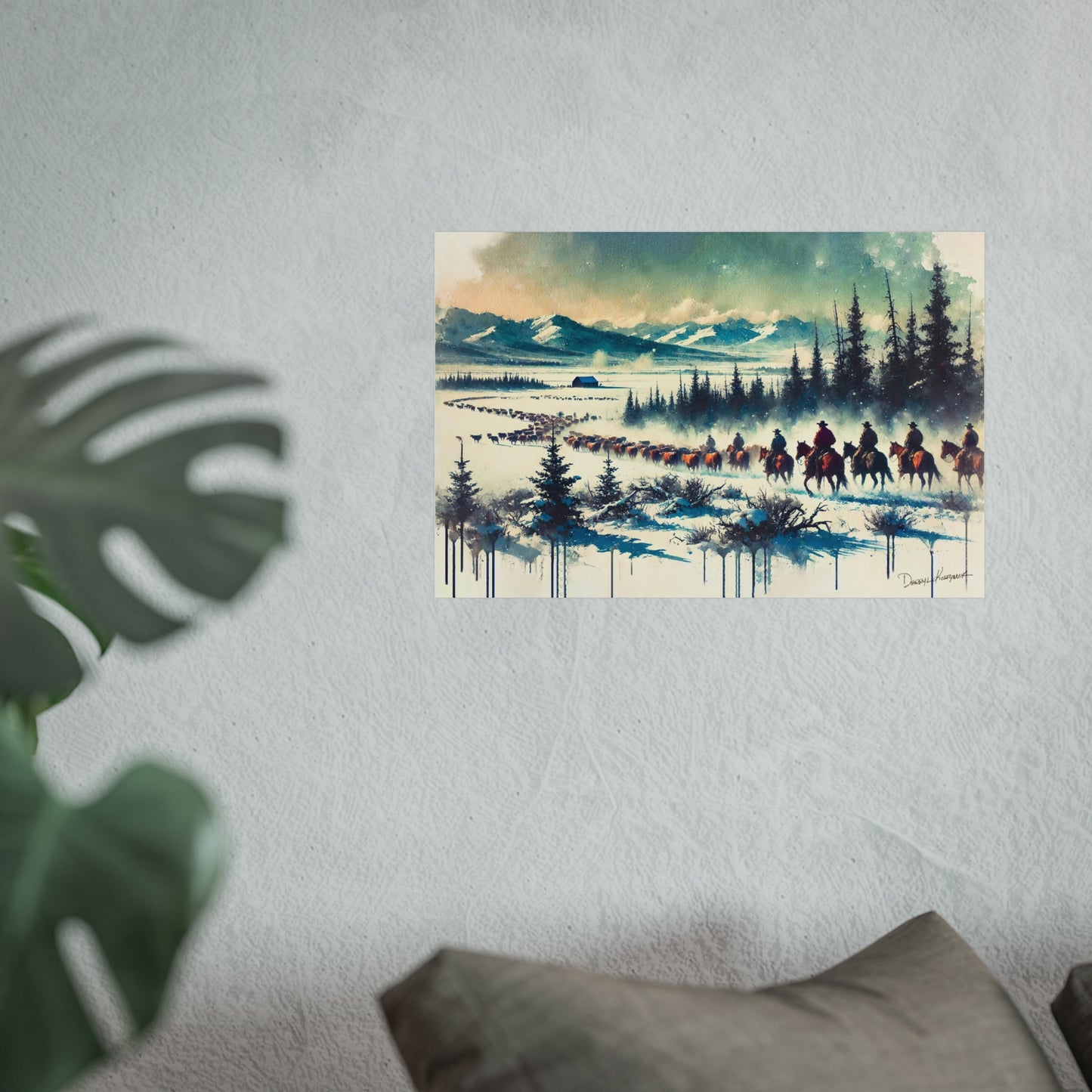 Framed artwork of a snowy landscape with cowboys on horseback, mounted on a wall.