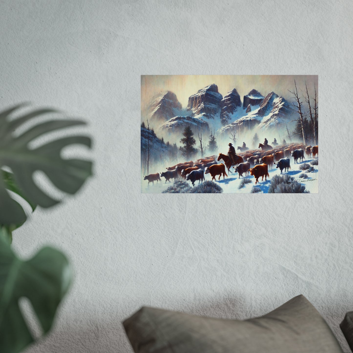 Framed painting of a snowy landscape with cowboys and animals on a wall.
