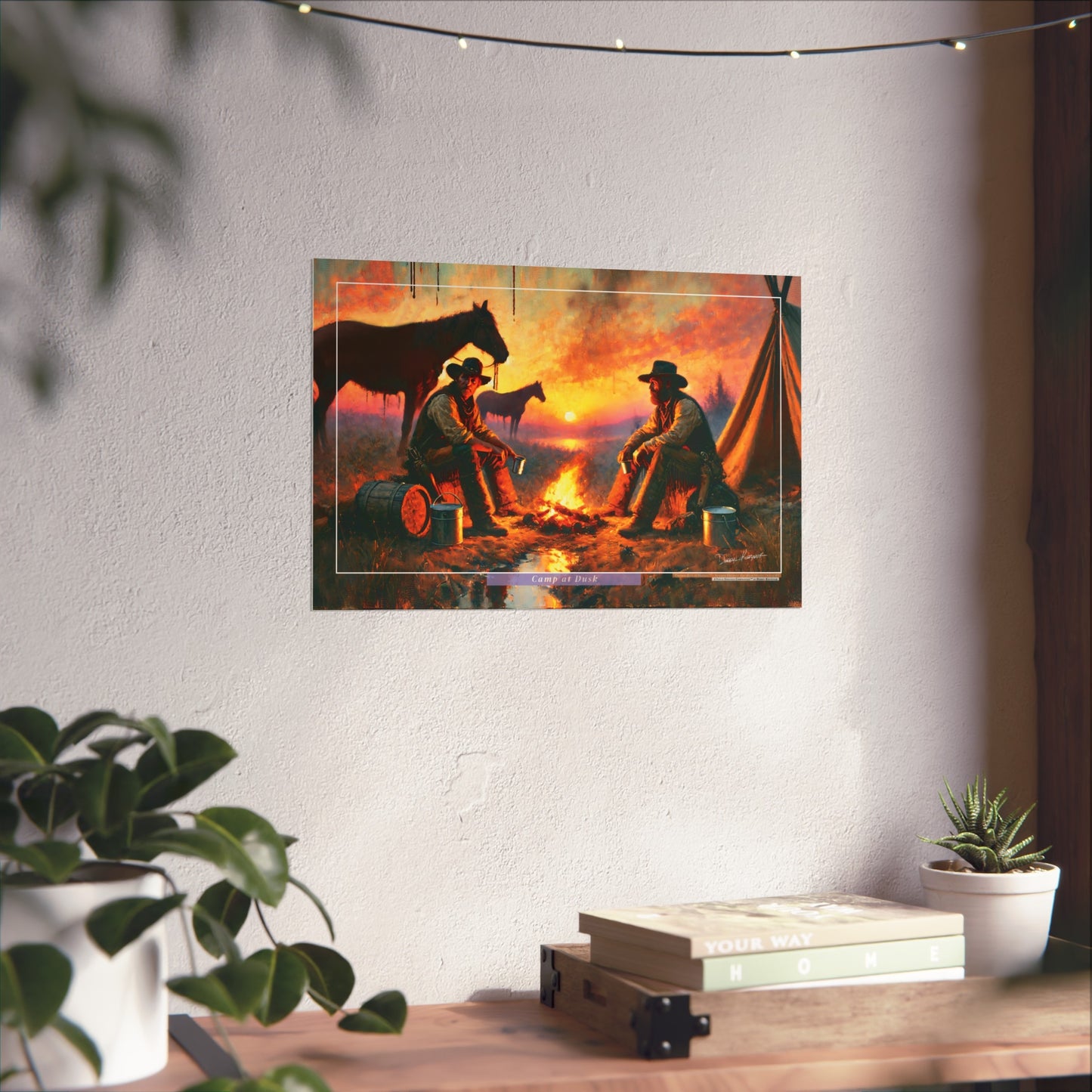 Two cowboys by a campfire with horses on a wall, below string lights and plants.