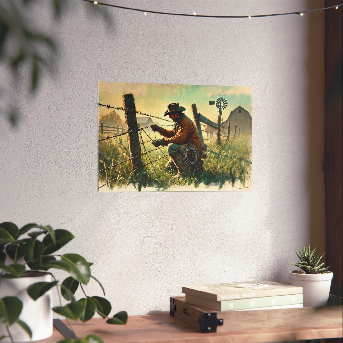 Painting of a cowboy working on a fence on a wall above a desk with plants.