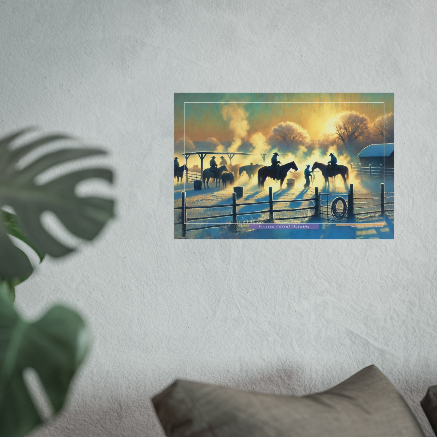Framed artwork of a sunset scene with cowboys on horseback, mounted on a wall.