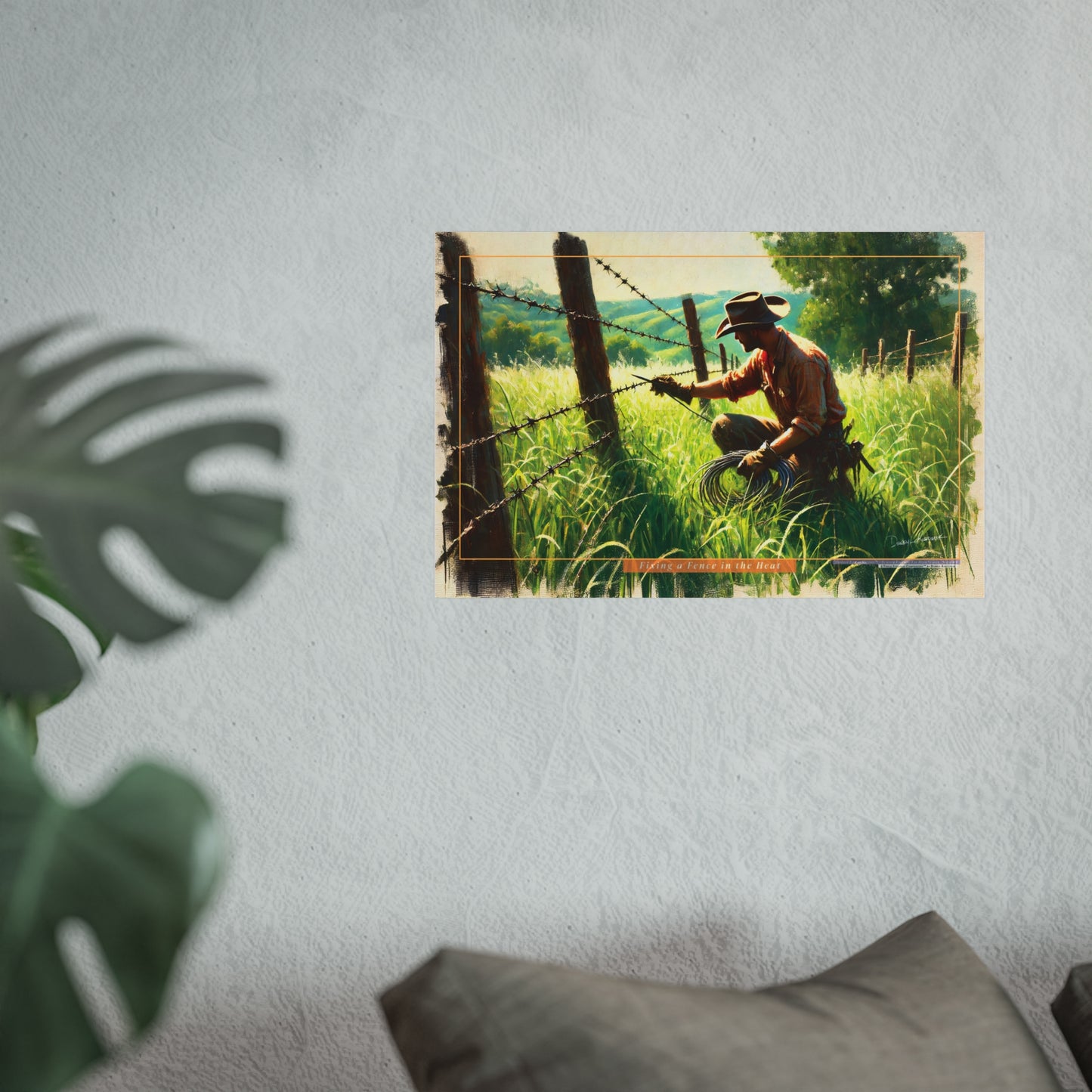cowboy working on a barbed wire fence in a field, framed as a decorative wall art.