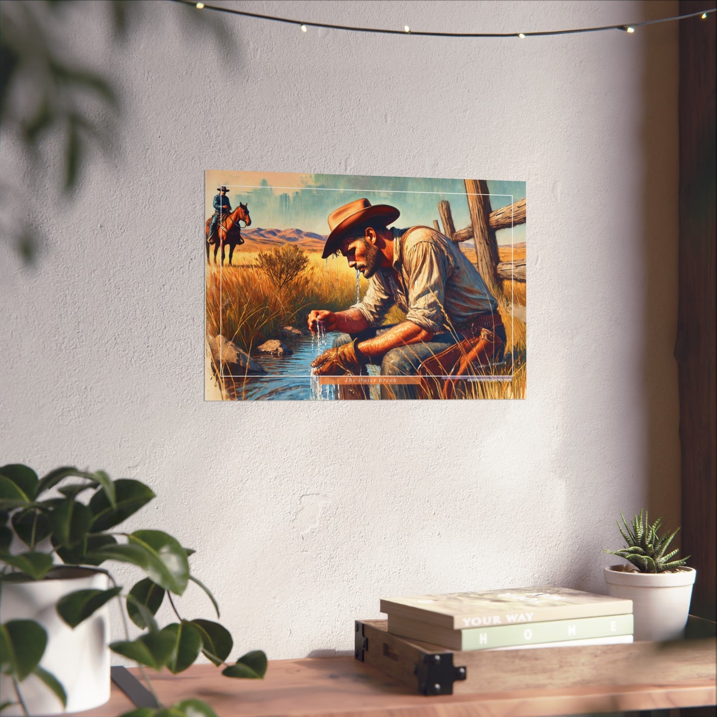 Poster of a cowboy by a stream on a wall with decor elements below.