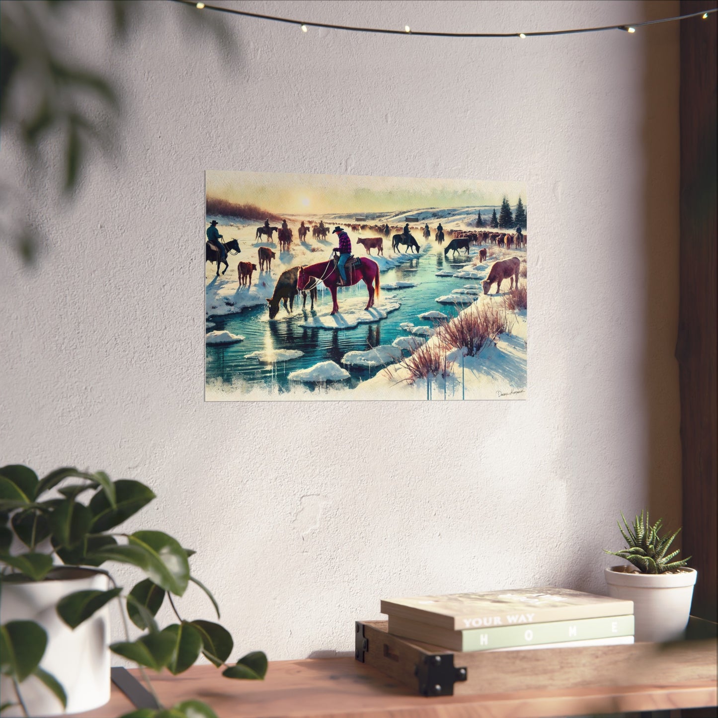 Poster of a winter scene with cowboys on horseback and animals near a frozen lake, hanging on a wall.