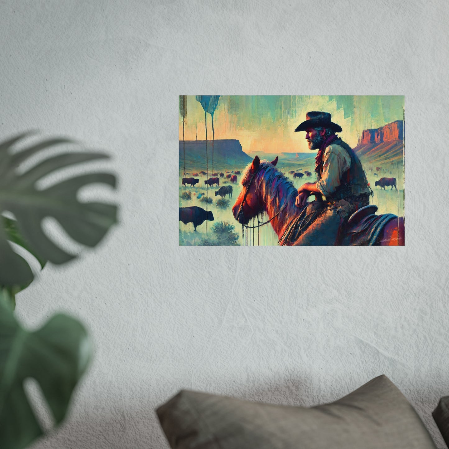 Cowboy on horseback with landscape and animals in the background, framed on a wall.