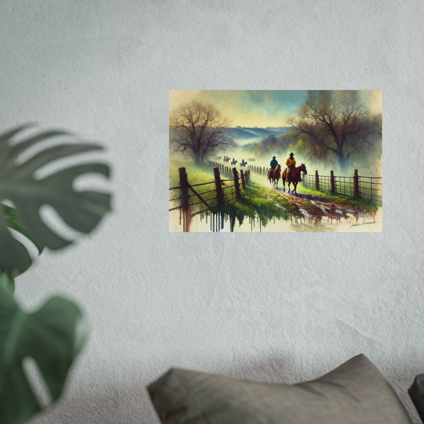 Painting of two cowboys on horseback by a fence with a scenic landscape, displayed on a wall.