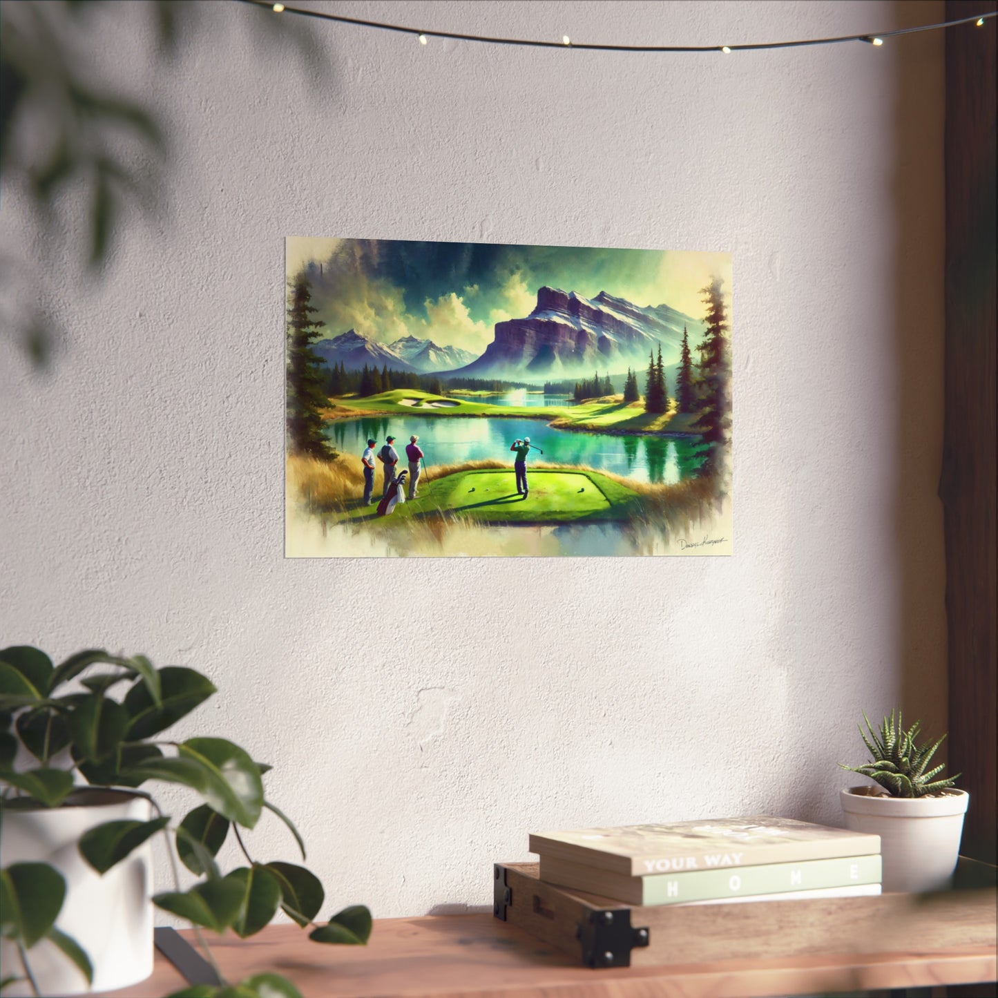 Giclee print of a mountain landscape with people on a golf course hanging on a wall.