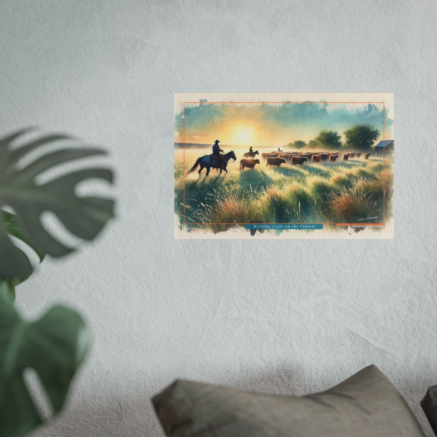 Poster of a cowboy on a horse with cattle in a field, displayed on a wall.