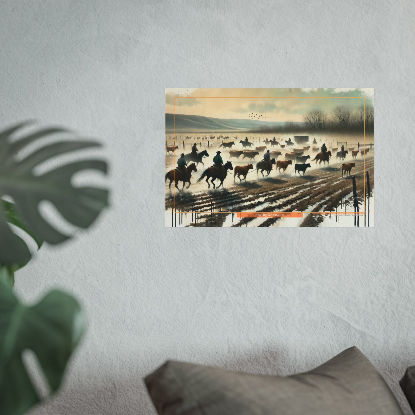 Poster of cowboys on horses in a field with a plant and pillow in the foreground.