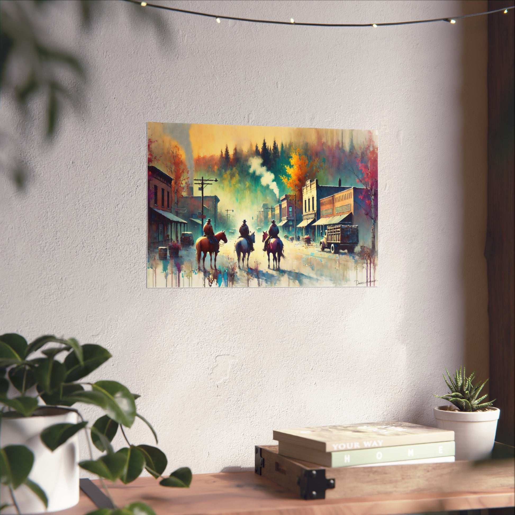 Colorful painting of a town scene with cowboys on horses hanging on a wall.