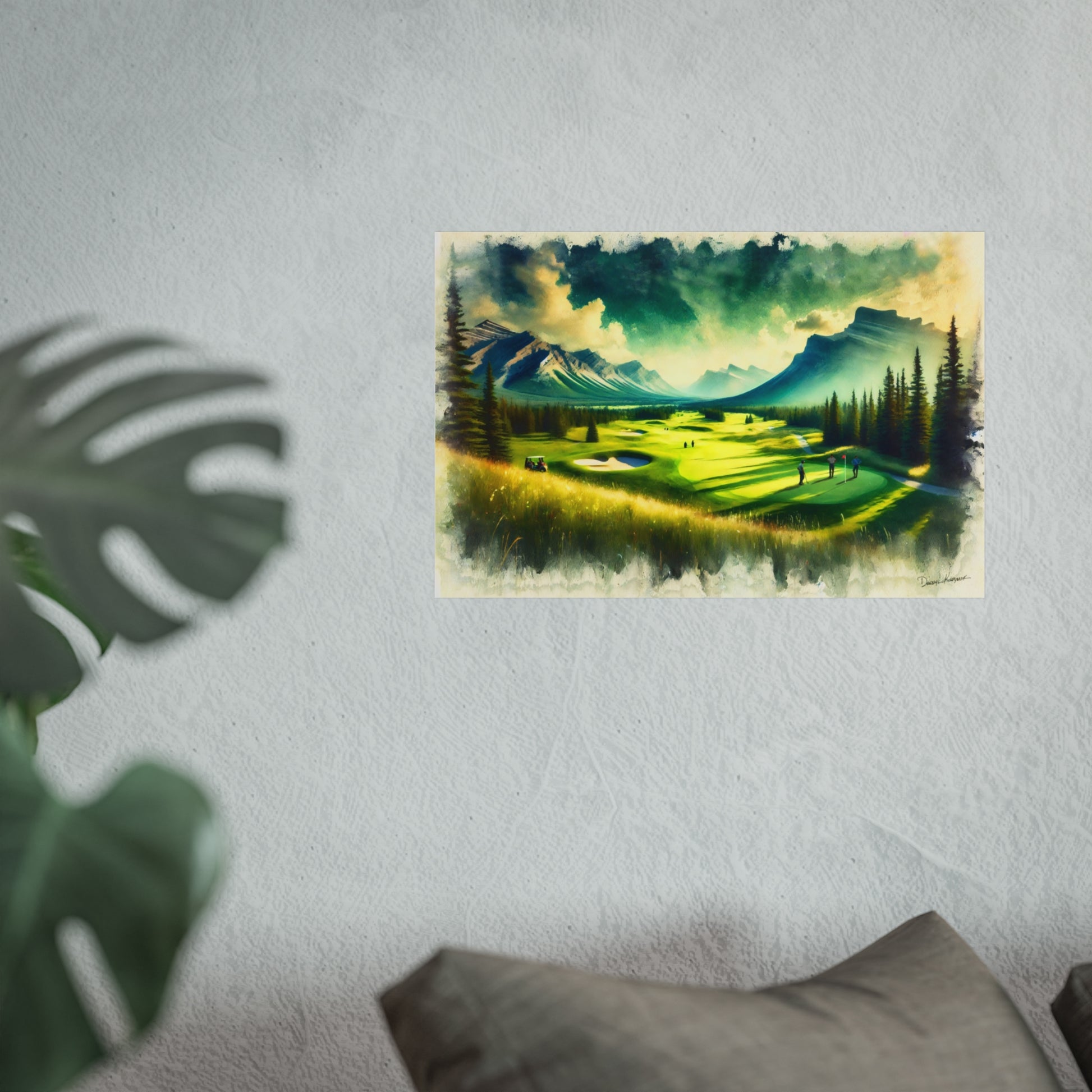 Fine art print of a golf course with mountains on a wall, with a plant and pillow in the foreground.
