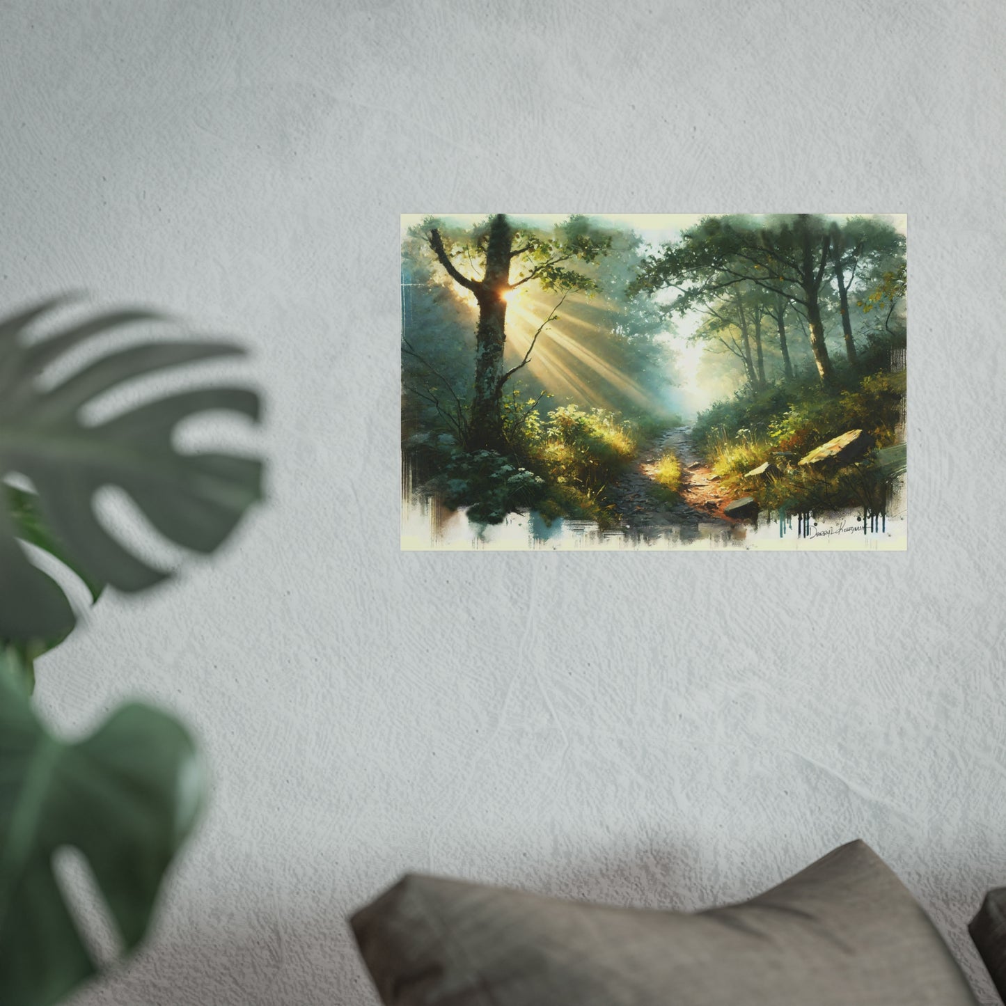 Framed artwork of a forest scene with sunlight filtering through trees on a wall.