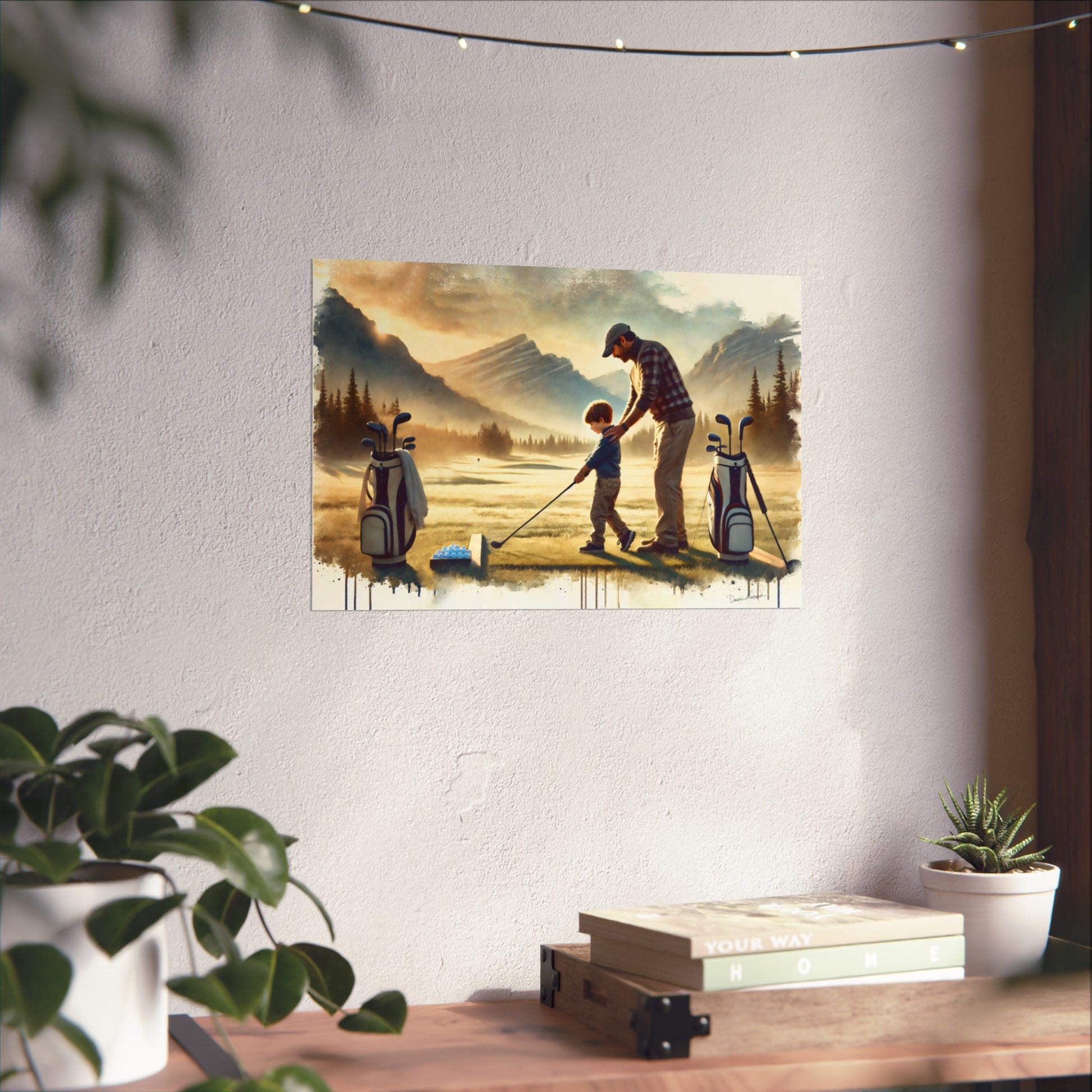 Fine art print of a man and child playing golf on a mountain landscape hanging on a wall.