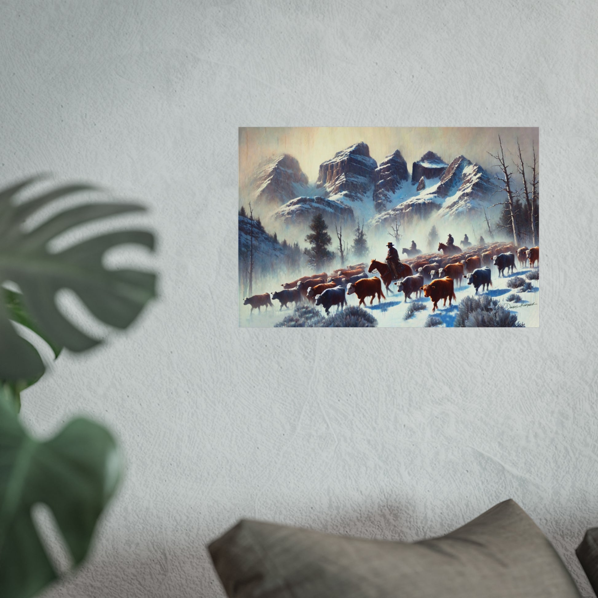 Framed painting of a snowy landscape with cowboys and animals on a wall.