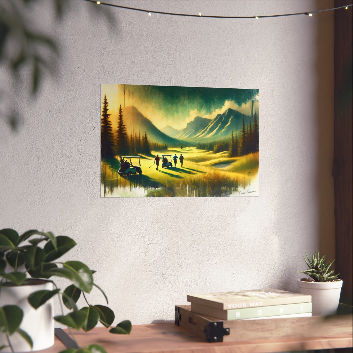 Painting of a scenic landscape with mountains and trees on a wall above a desk.