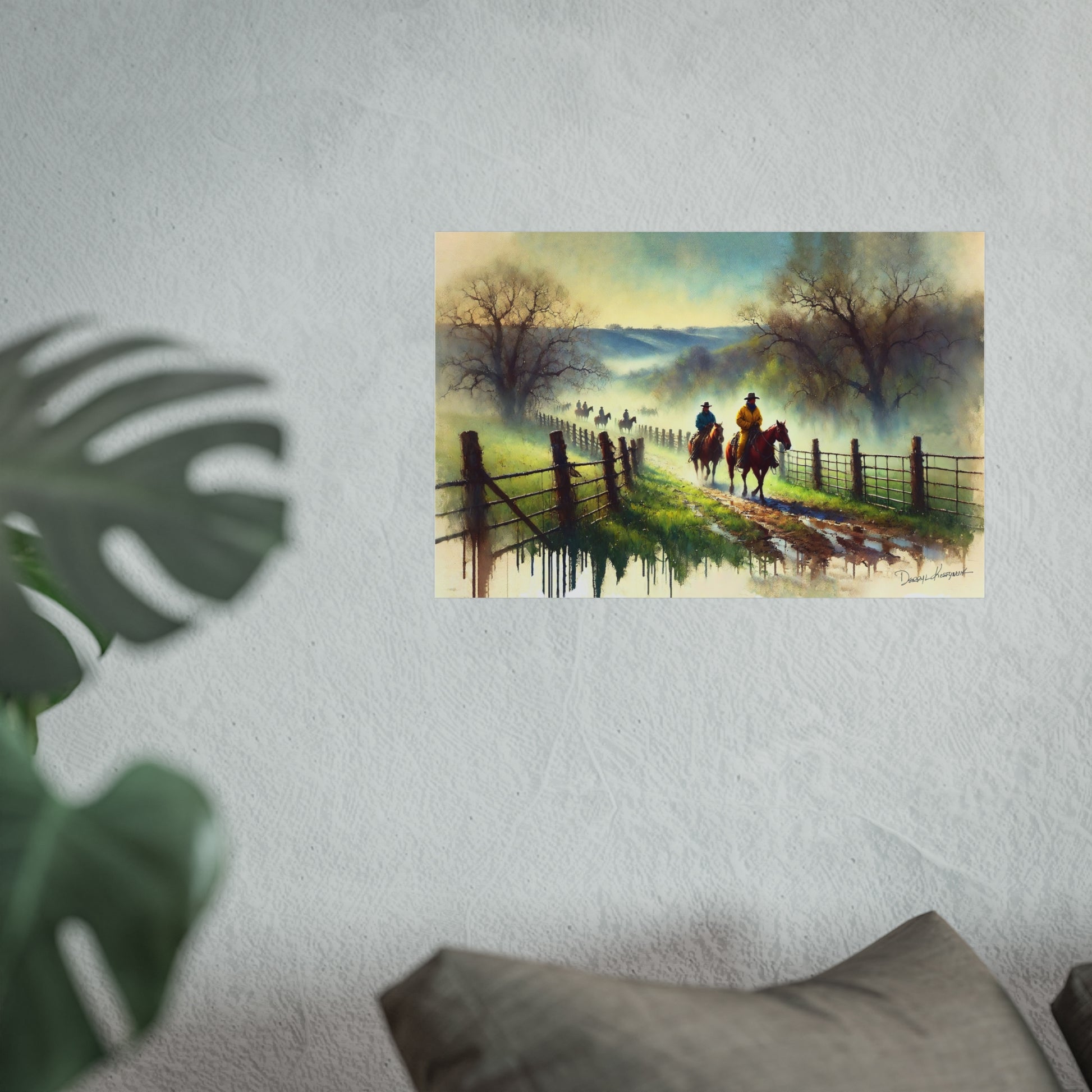 Painting of two cowboys on horseback by a fence with a scenic landscape, displayed on a wall.